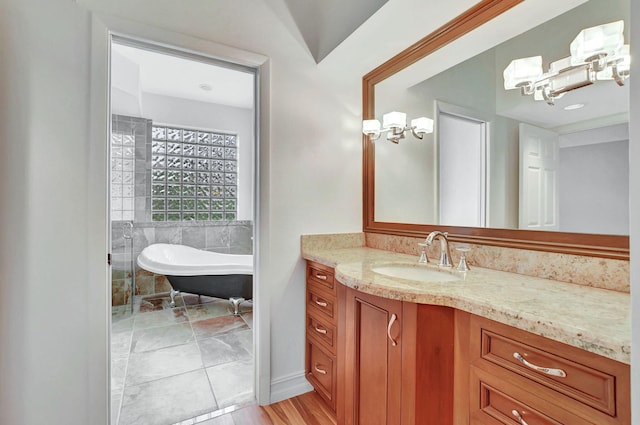 bathroom featuring a tub to relax in and vanity