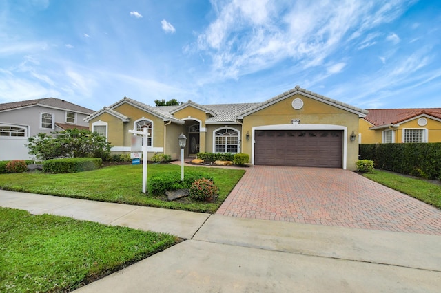 ranch-style home with a garage and a front yard