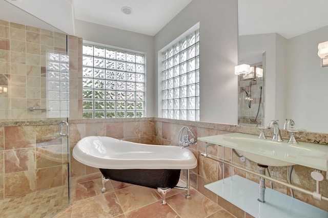 bathroom with sink, tile walls, tile patterned floors, and shower with separate bathtub