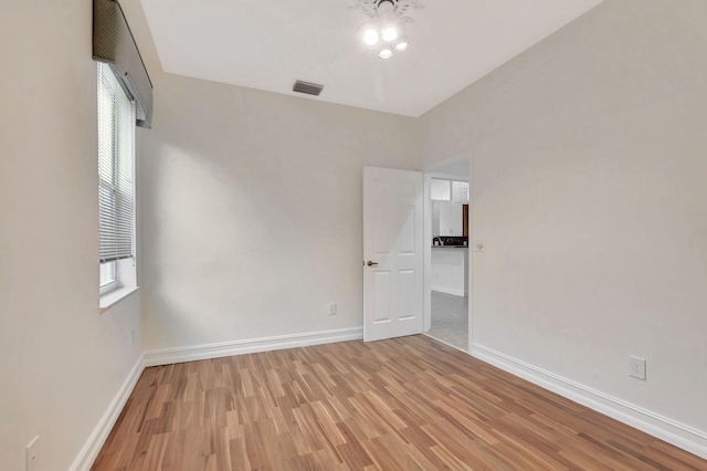 empty room featuring light wood-type flooring and a healthy amount of sunlight