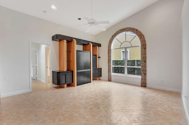 unfurnished living room featuring light tile patterned floors and ceiling fan