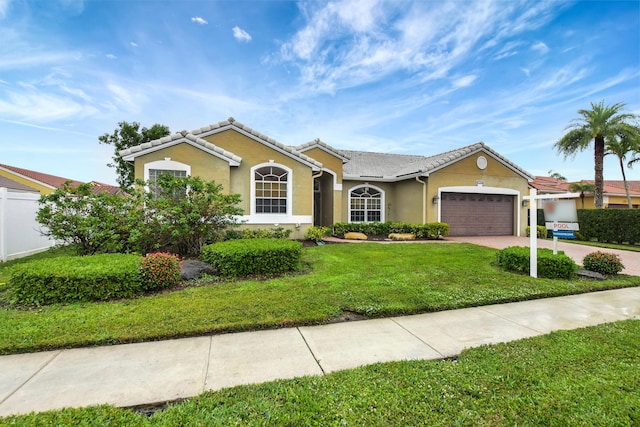 ranch-style home featuring a garage and a front lawn