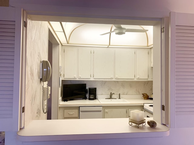 kitchen with ceiling fan, sink, white cabinetry, and stainless steel dishwasher