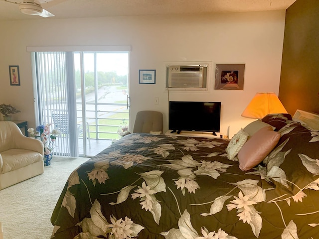 carpeted bedroom featuring access to outside, ceiling fan, and a wall mounted air conditioner