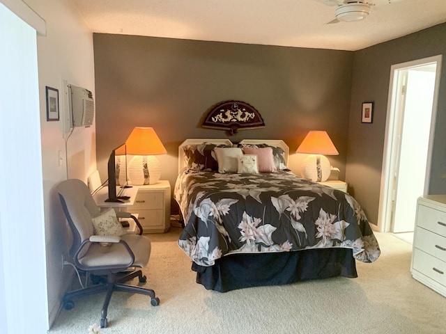 carpeted bedroom featuring ceiling fan and a wall mounted AC