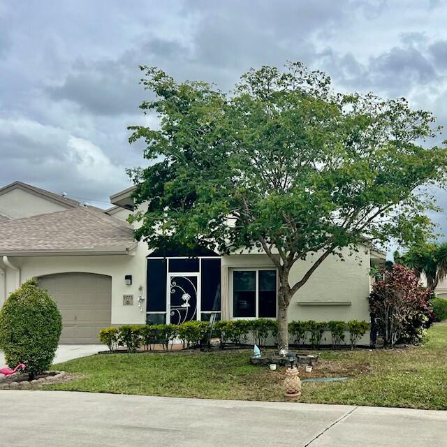 view of front of house with a front lawn and a garage