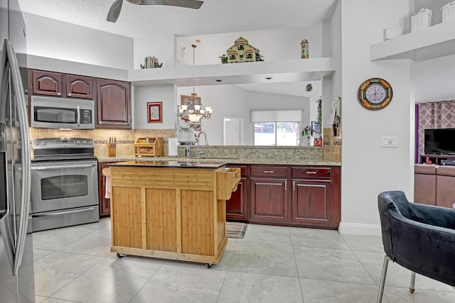 kitchen featuring appliances with stainless steel finishes, pendant lighting, tasteful backsplash, sink, and a textured ceiling