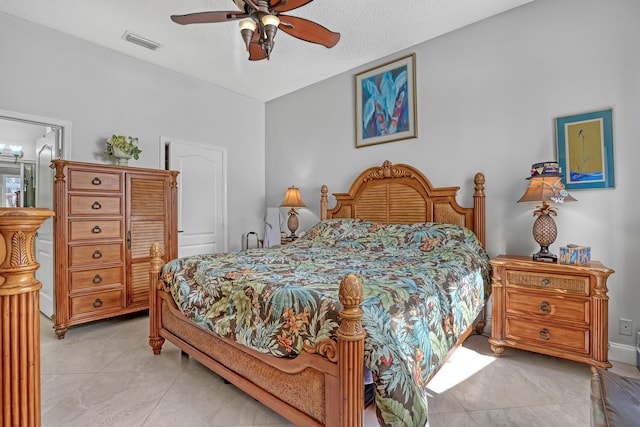 tiled bedroom featuring ceiling fan and a textured ceiling