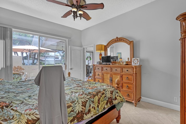 bedroom featuring ceiling fan, light tile patterned floors, a textured ceiling, and access to outside