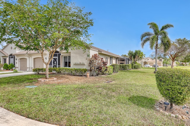 view of front of property with a garage, a lanai, and a front lawn