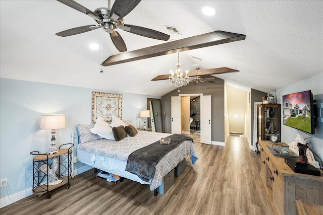 bedroom featuring wood-type flooring, a textured ceiling, and lofted ceiling