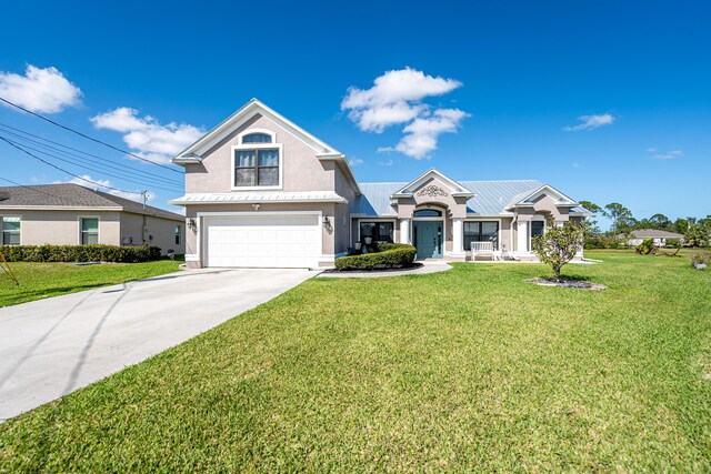 view of front of house with a garage and a front lawn