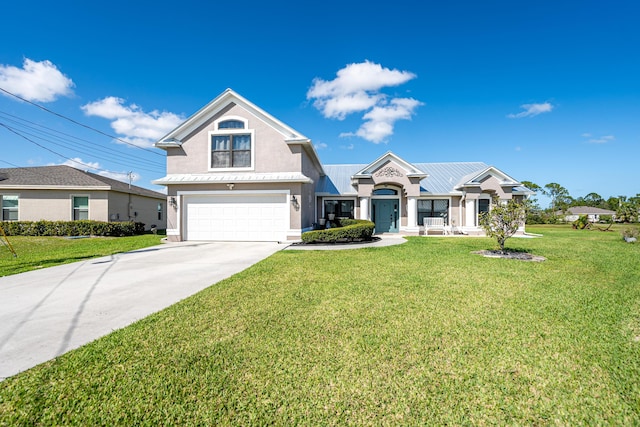 view of front of property featuring a front lawn and a garage