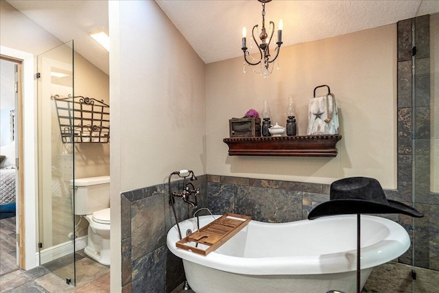 bathroom featuring a tub, tile walls, an inviting chandelier, and toilet