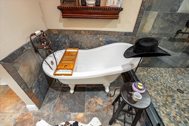 bathroom featuring a bath and tile walls