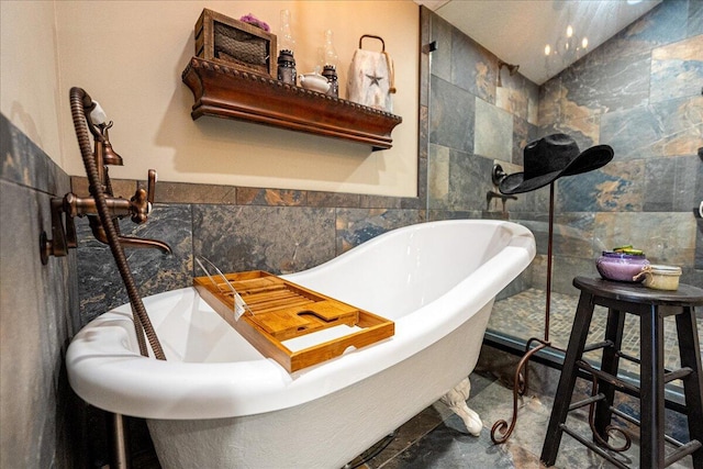 bathroom featuring tile walls and a bath