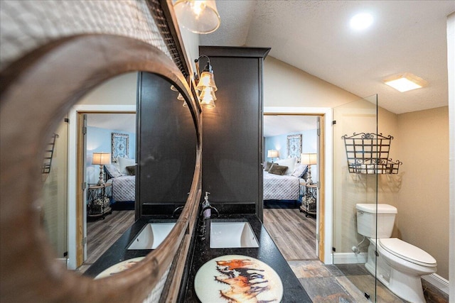 corridor with dark hardwood / wood-style flooring, sink, and vaulted ceiling