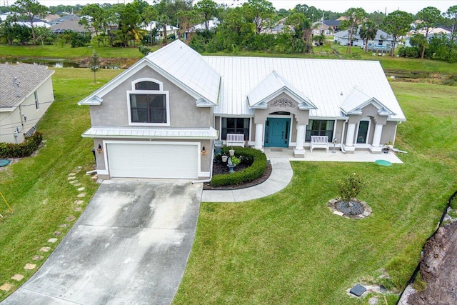 view of front of home with a front yard and a garage