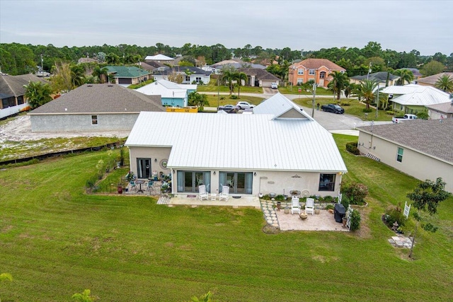 rear view of property with a patio area and a lawn