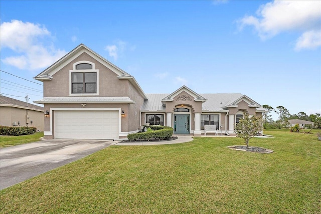 view of front of house with a garage and a front lawn