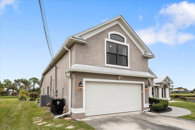 view of property exterior featuring a garage, a yard, and central AC unit