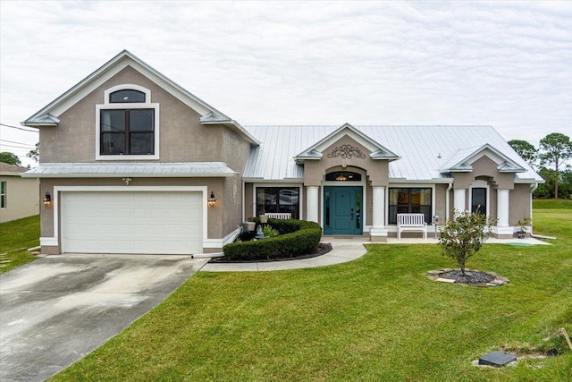 view of front of home featuring a front yard and a garage