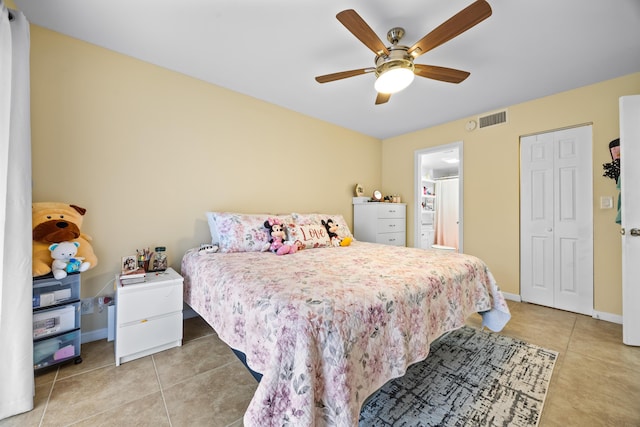 tiled bedroom featuring ceiling fan and a closet