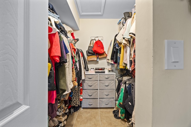 walk in closet with light tile patterned floors