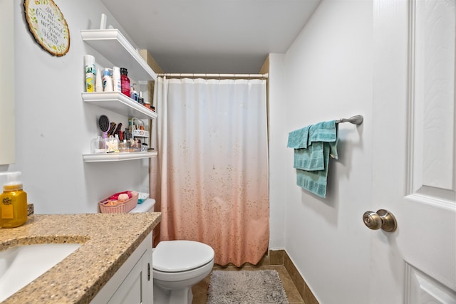 bathroom featuring toilet, vanity, and curtained shower