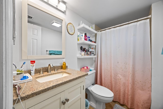 bathroom featuring toilet and vanity