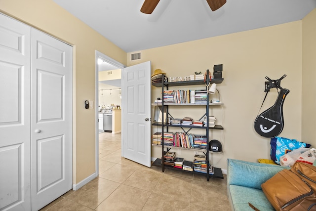 sitting room featuring ceiling fan and light tile patterned floors