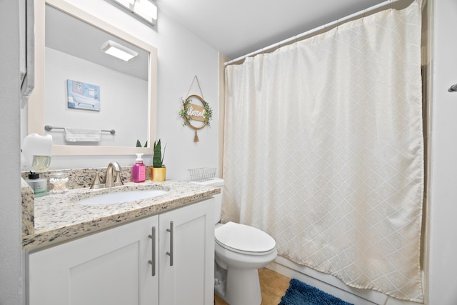 bathroom featuring toilet, vanity, and a shower with shower curtain