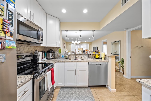 kitchen with white cabinetry, stainless steel appliances, kitchen peninsula, and sink