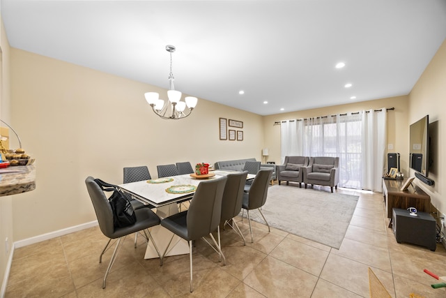 dining area with a notable chandelier and light tile patterned flooring