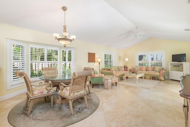 dining area featuring lofted ceiling, a healthy amount of sunlight, and ceiling fan with notable chandelier