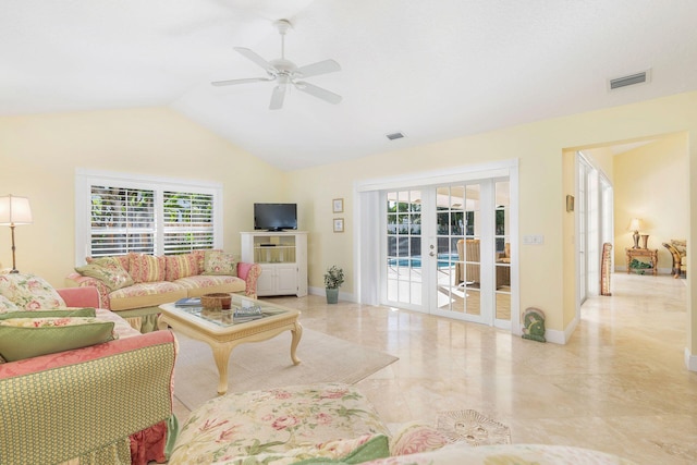 living room with french doors, ceiling fan, a healthy amount of sunlight, and lofted ceiling