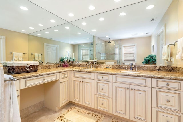 bathroom featuring tile patterned flooring, vanity, and a shower with shower door