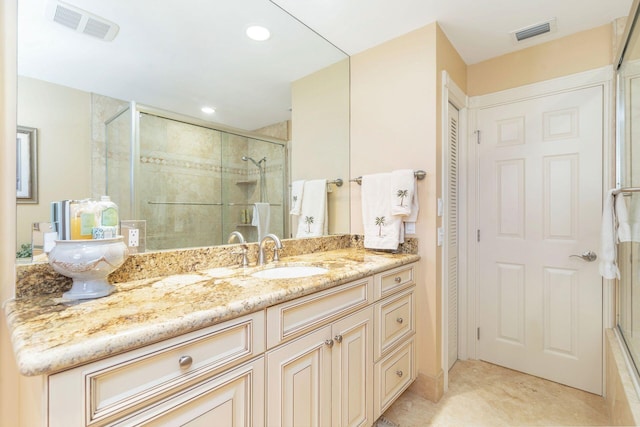 bathroom featuring vanity and a shower with shower door