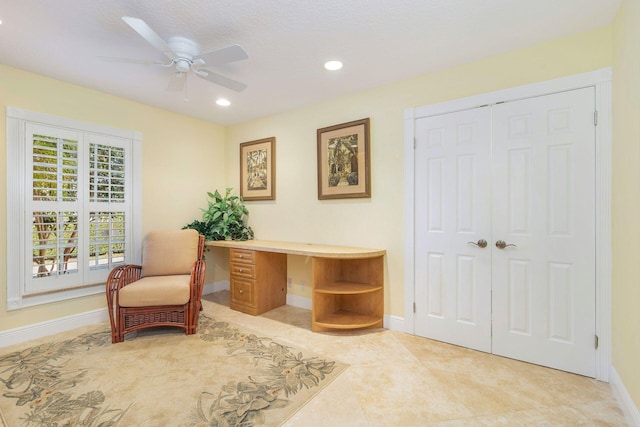 interior space with light tile patterned flooring and ceiling fan