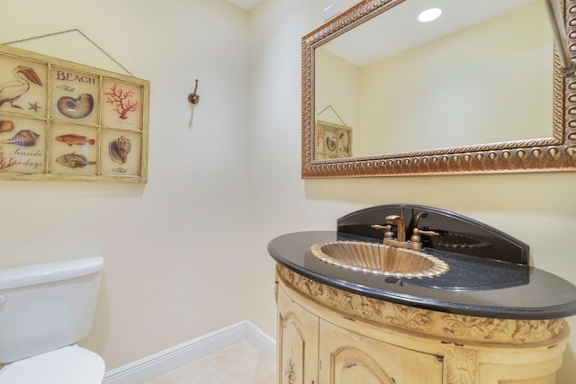 bathroom with vanity, toilet, and tile patterned flooring