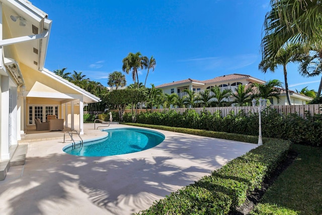 view of pool featuring a patio and french doors