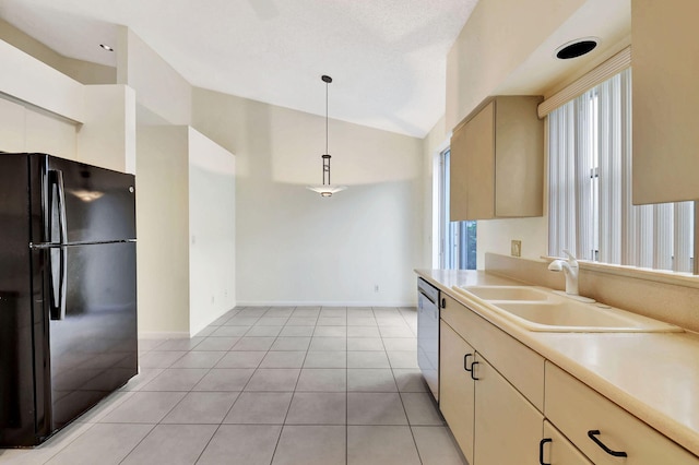 kitchen featuring sink, decorative light fixtures, vaulted ceiling, black refrigerator, and stainless steel dishwasher