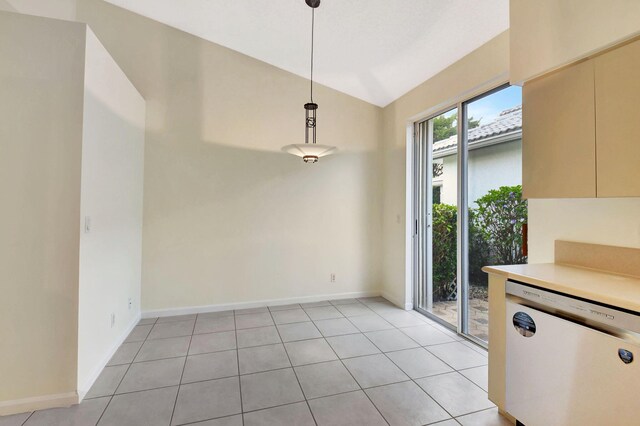 unfurnished dining area featuring lofted ceiling and light tile patterned floors