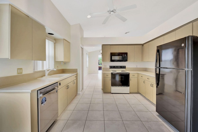 kitchen with sink, black appliances, cream cabinetry, and light tile patterned flooring