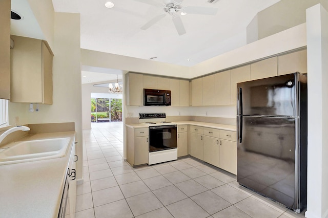 kitchen featuring sink, black appliances, light tile patterned floors, ceiling fan with notable chandelier, and cream cabinetry