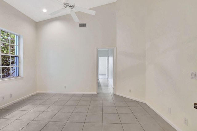 empty room with light tile patterned flooring and ceiling fan