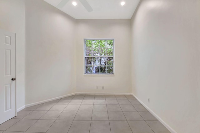 tiled empty room featuring ceiling fan