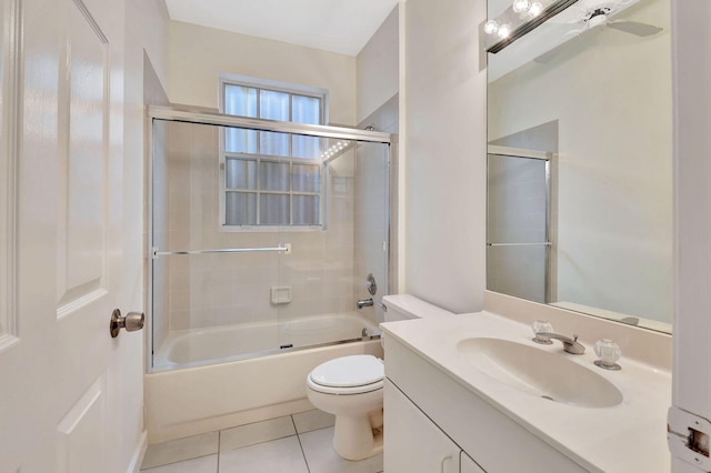 full bathroom with shower / bath combination with glass door, vanity, ceiling fan, toilet, and tile patterned floors