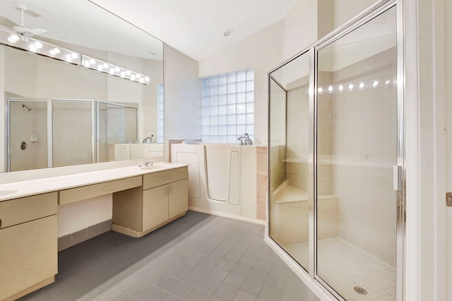 bathroom featuring vanity, vaulted ceiling, shower with separate bathtub, and ceiling fan