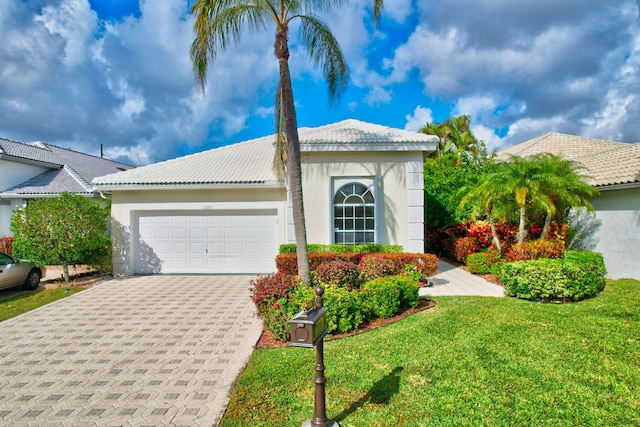 view of front facade with a garage and a front yard